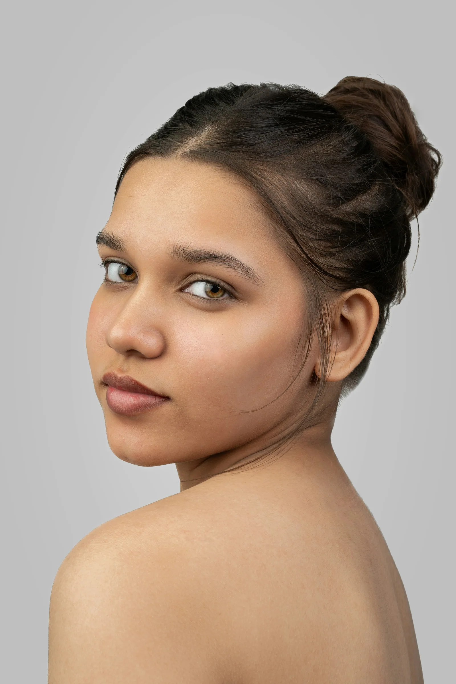 A portrait of a woman looking back over her shoulder
