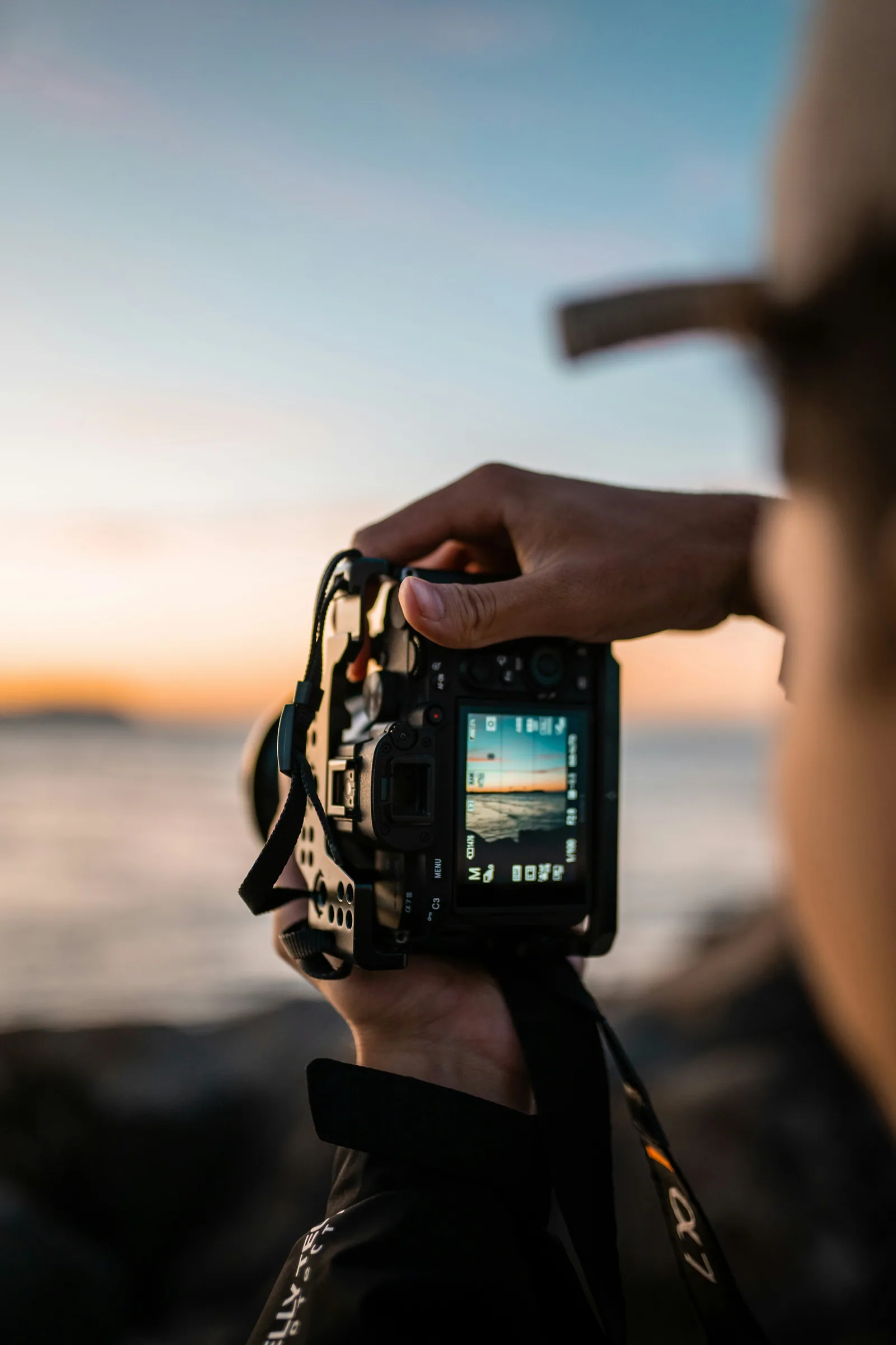Person holding black dslr camera