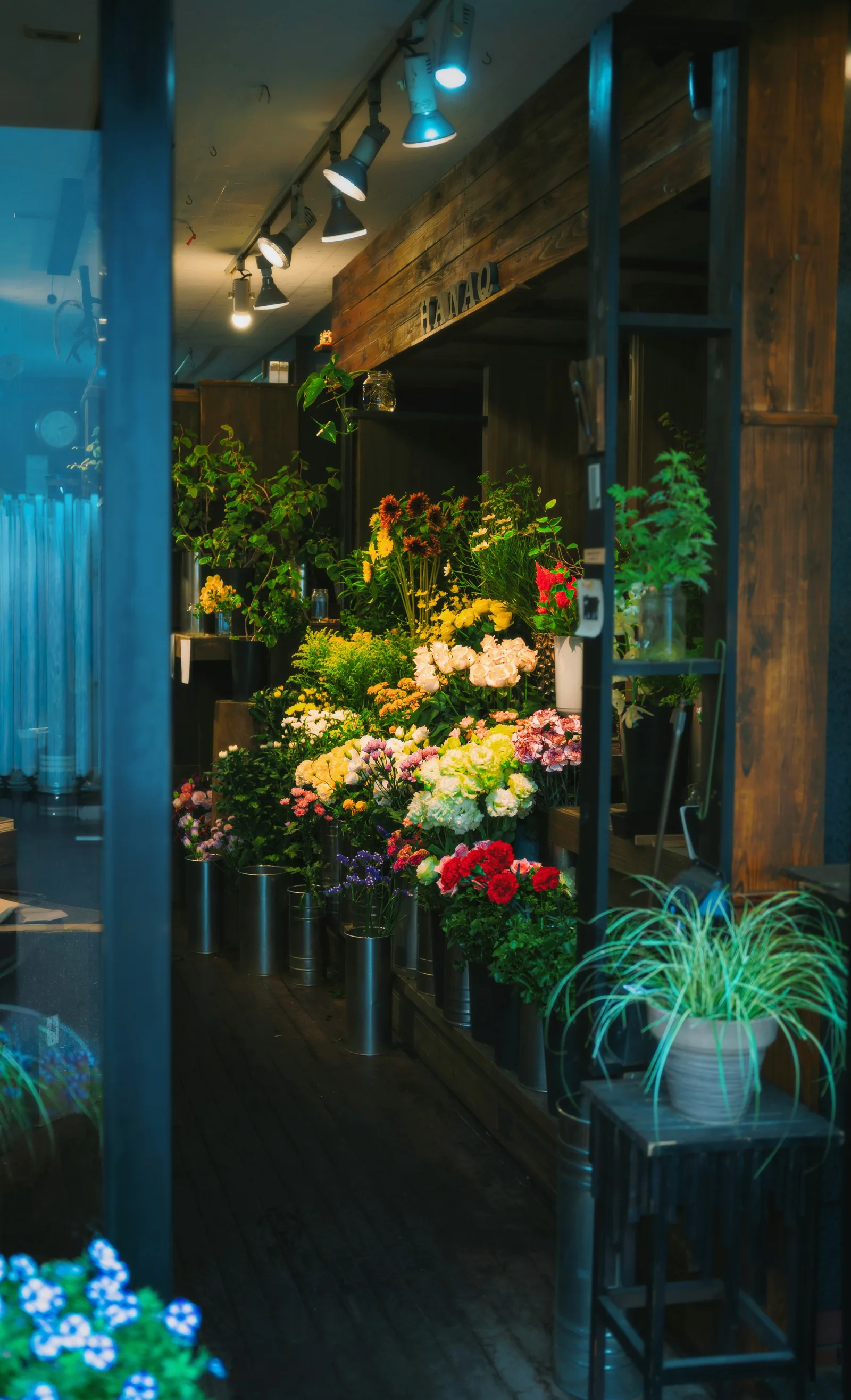 A vibrant flower shop entrance with many colorful blooms