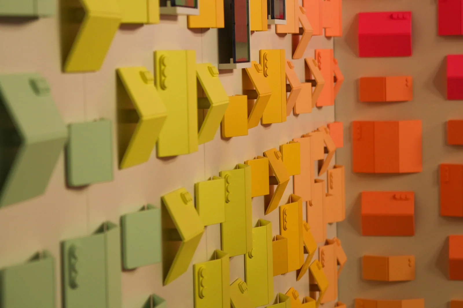 Colorful arrow and hexagonal paint swatches displayed on a wall