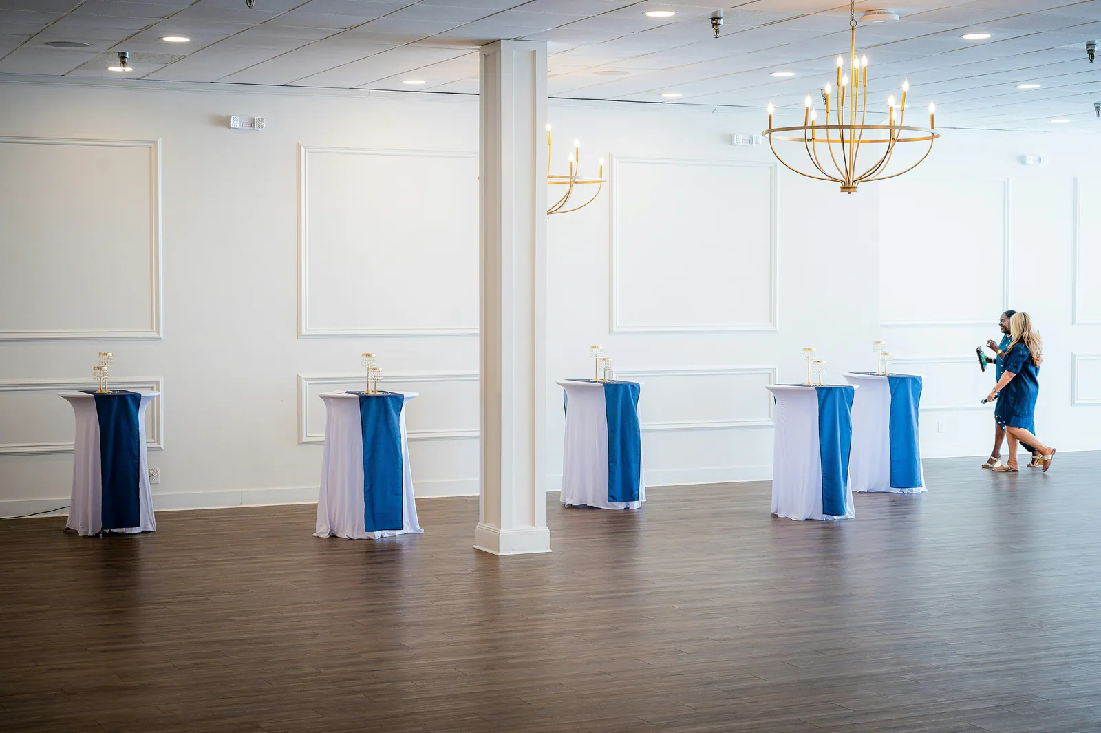Empty event space with decorated high-top tables