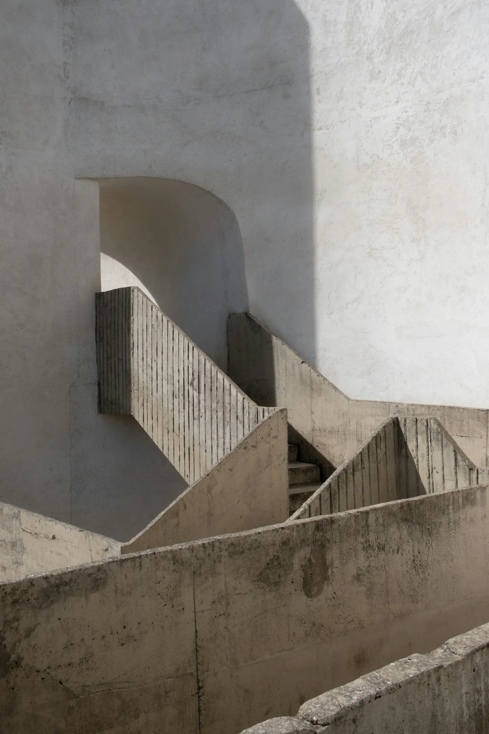Concrete stairs and walls casting sharp shadows
