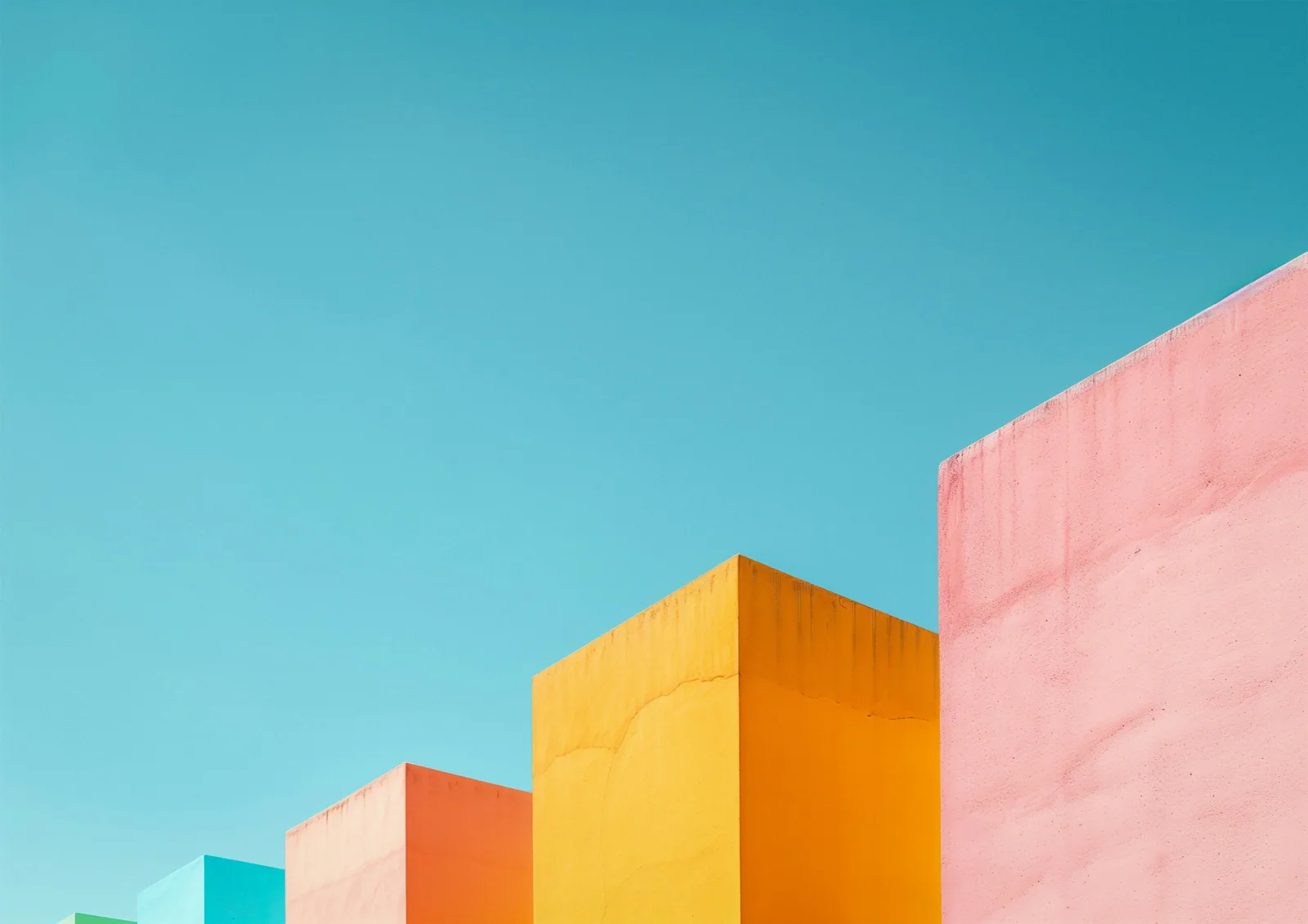 Blocks of pink, orange and teal against a blue sky