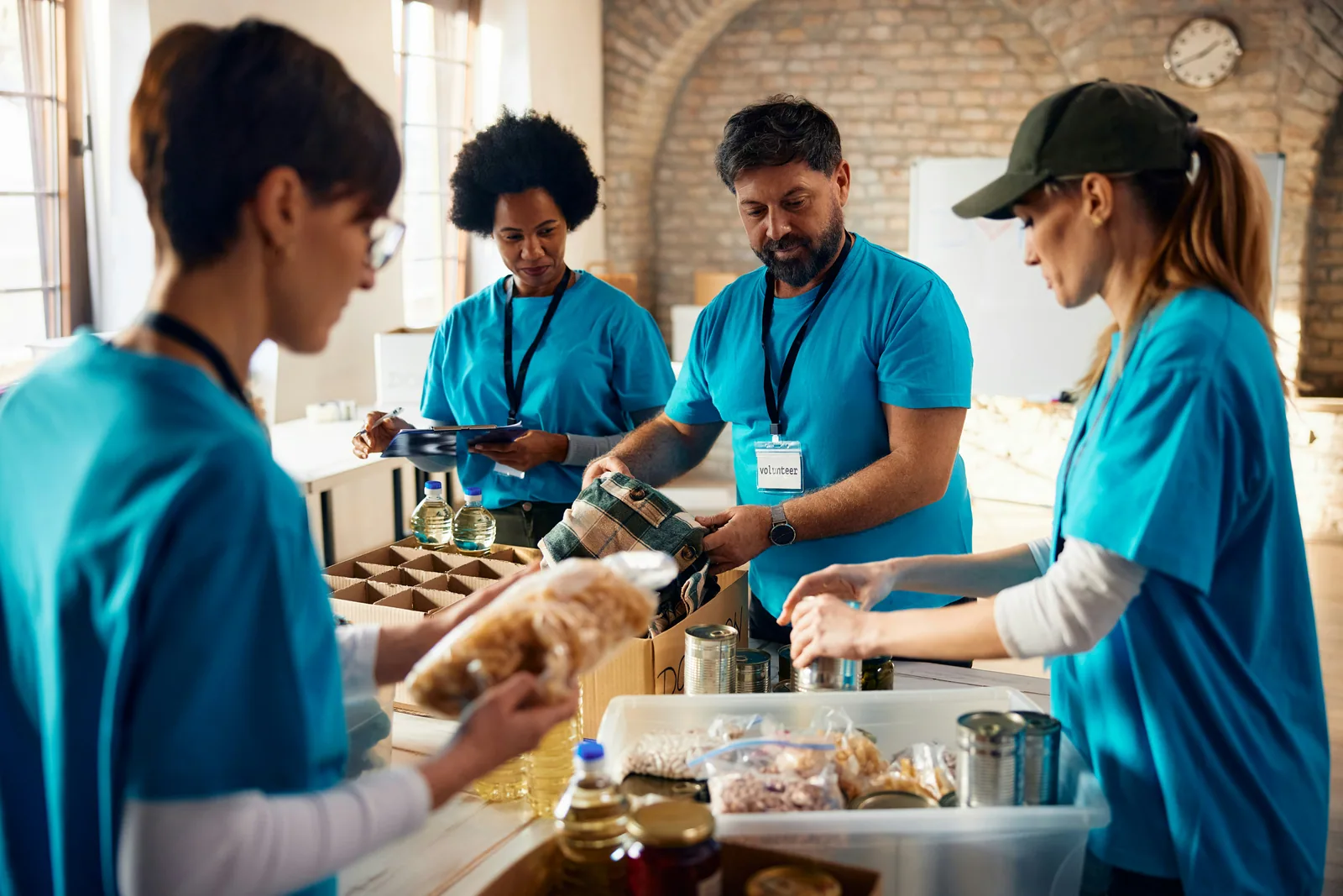 Volunteers in matching shirts sorting donated food