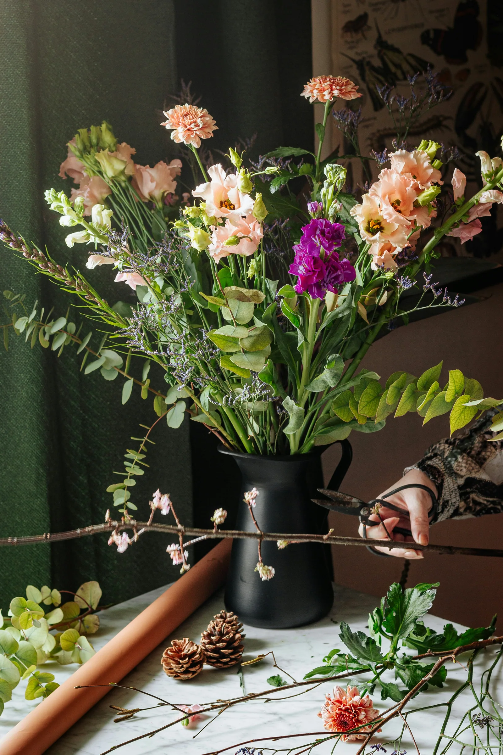 White and purple flowers in black vase