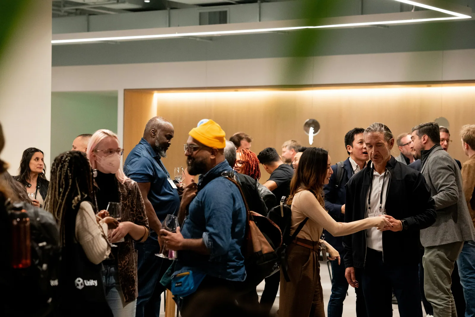 People mingling at an indoor event with warm lighting
