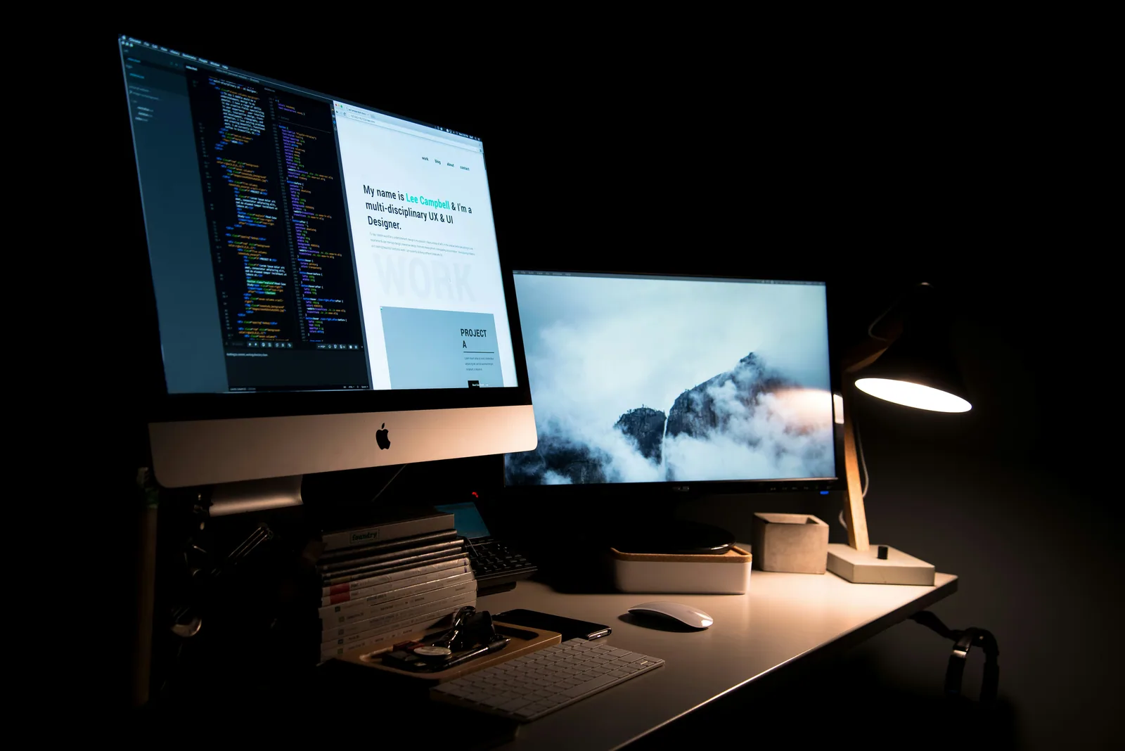 A dark desk at night with a website open on the screen